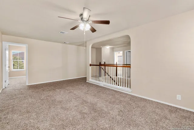 an empty room with windows and entryway