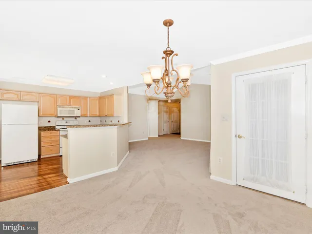 a view of a kitchen with a sink and dishwasher a refrigerator with wooden floor
