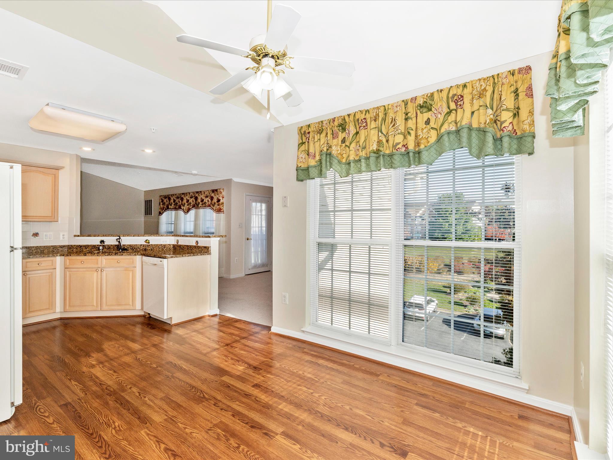 2509 Shelley Circle, Unit 5 3A Frederick, MD 21702 - Photo 21 of 47 a large white kitchen with kitchen island a stove a wooden floor and a sink