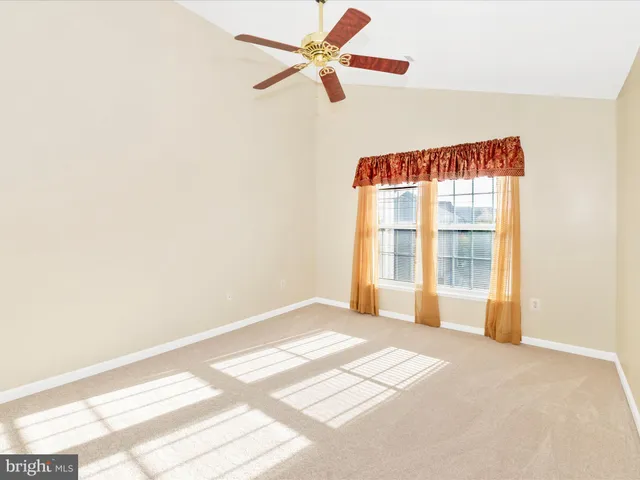 a view of a room with a window and a ceiling fan