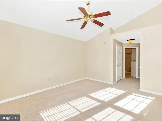 a view of a room with wooden floor and white walls