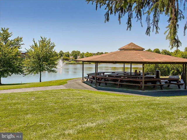 a swimming pool view with a seating space
