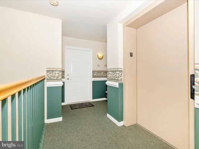 a view of a kitchen with fridge and wooden floor