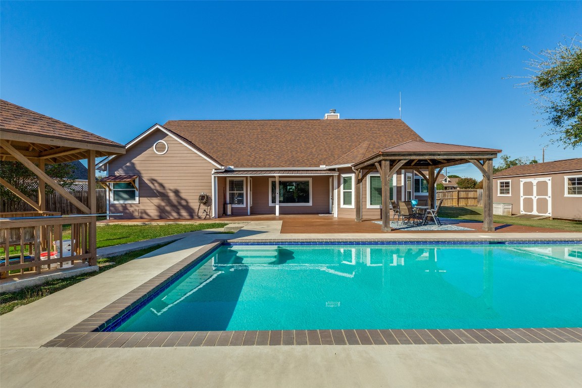 a house with swimming pool in front of it