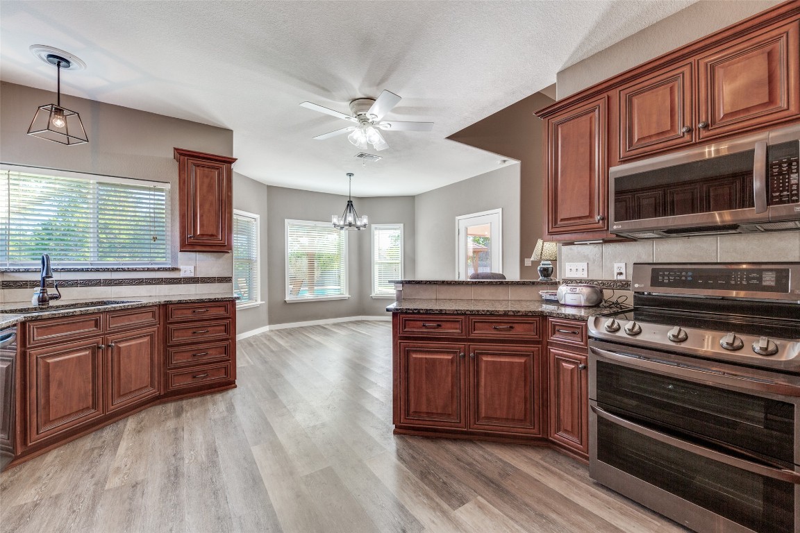 1536 Kings Ranch Road Bandera, TX 78003 - Photo 19 of 35 a kitchen with stainless steel appliances granite countertop a stove and cabinets