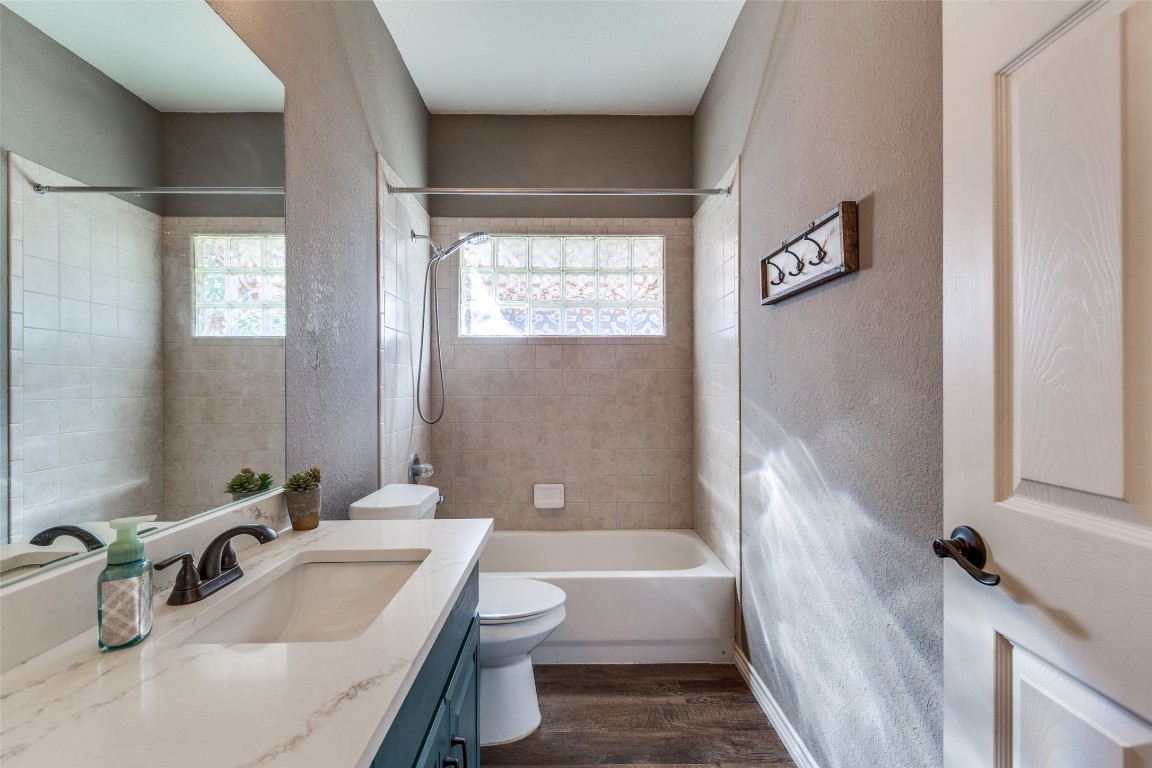 1536 Kings Ranch Road Bandera, TX 78003 - Photo 25 of 35 a bathroom with a sink a toilet a bathtub and shower