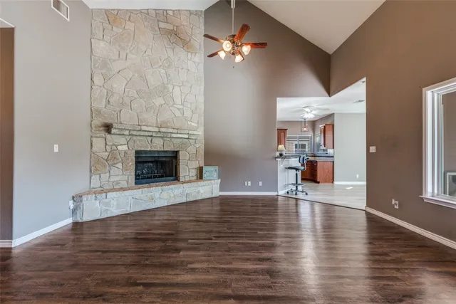 a kitchen with stainless steel appliances granite countertop a stove cabinets and wooden floor