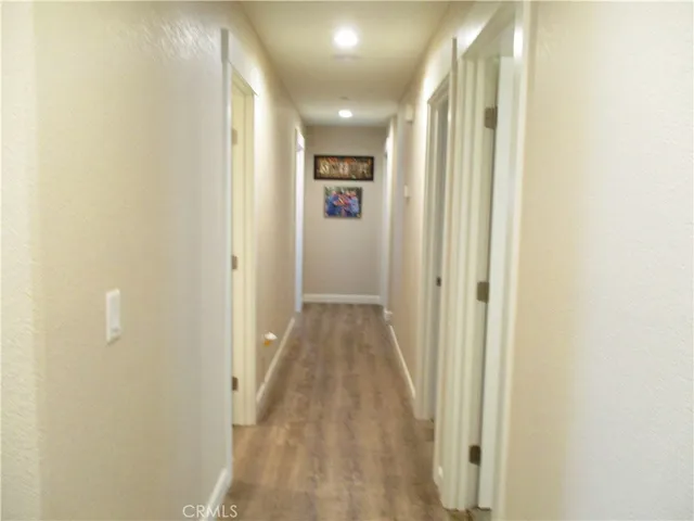 a view of a hallway with wooden floor