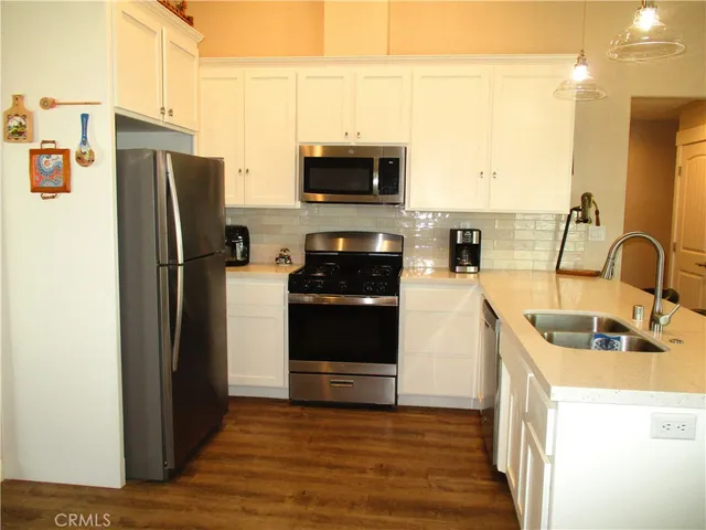 a kitchen with stainless steel appliances a refrigerator stove and sink