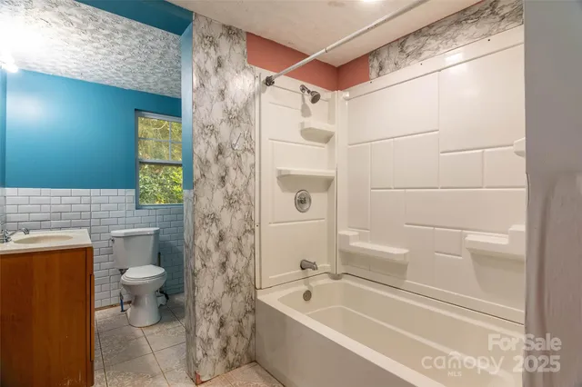 a bathroom with a bathtub and a toilet