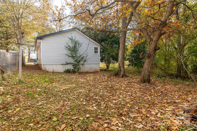 a view of backyard of house with green space