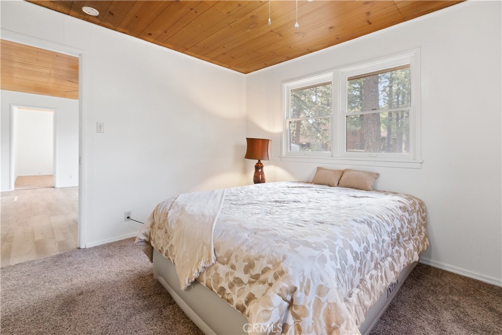 1777 Sparrow Road Wrightwood, CA 92397 - Photo 12 of 44 a bed sitting in a bedroom next to a window
