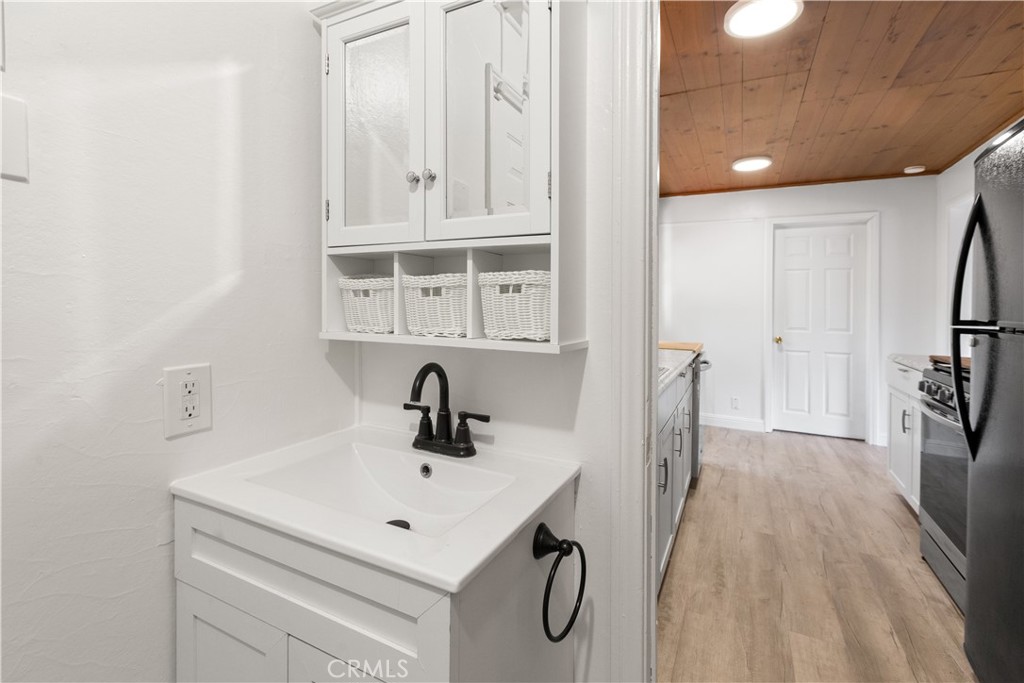 1777 Sparrow Road Wrightwood, CA 92397 - Photo 23 of 44 a bathroom with a sink a toilet and a mirror
