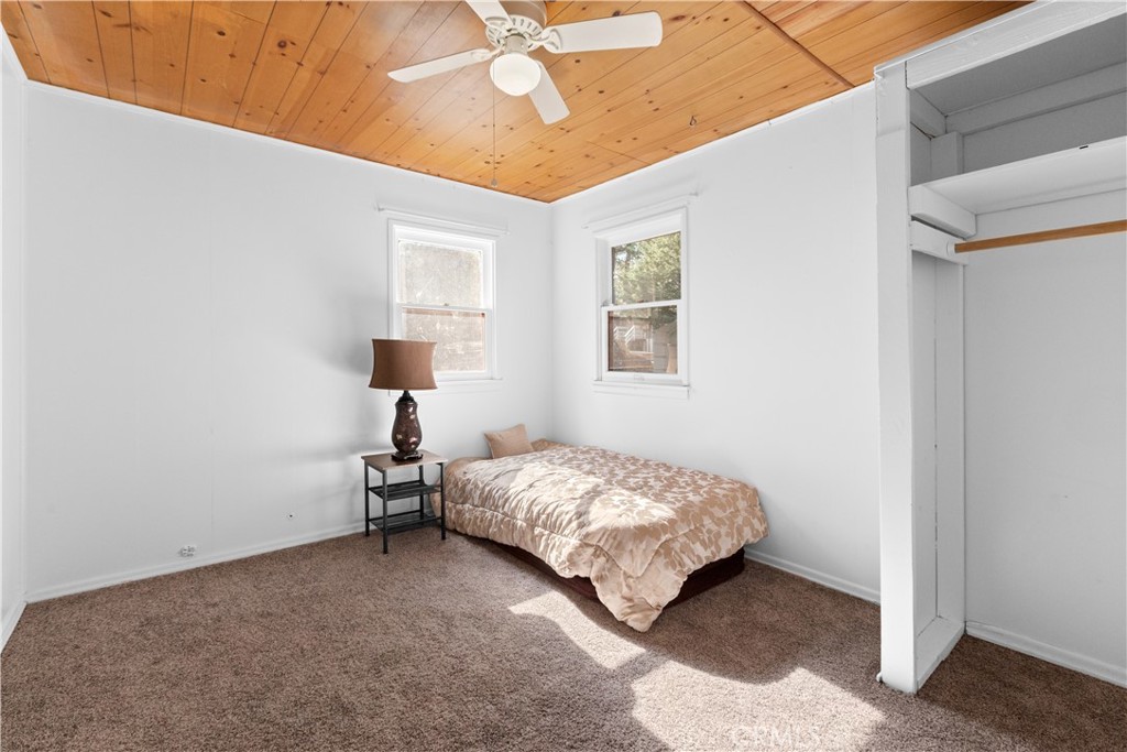 1777 Sparrow Road Wrightwood, CA 92397 - Photo 25 of 44 a bedroom with a bed and a window