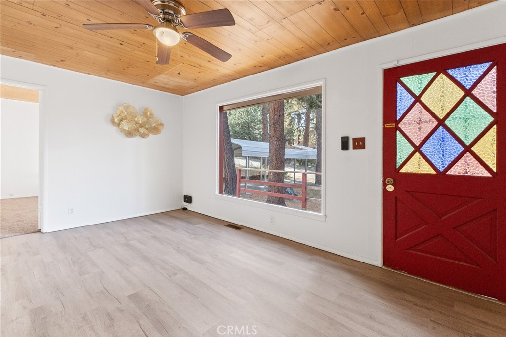 1777 Sparrow Road Wrightwood, CA 92397 - Photo 6 of 44 an empty room with windows and chandelier fan