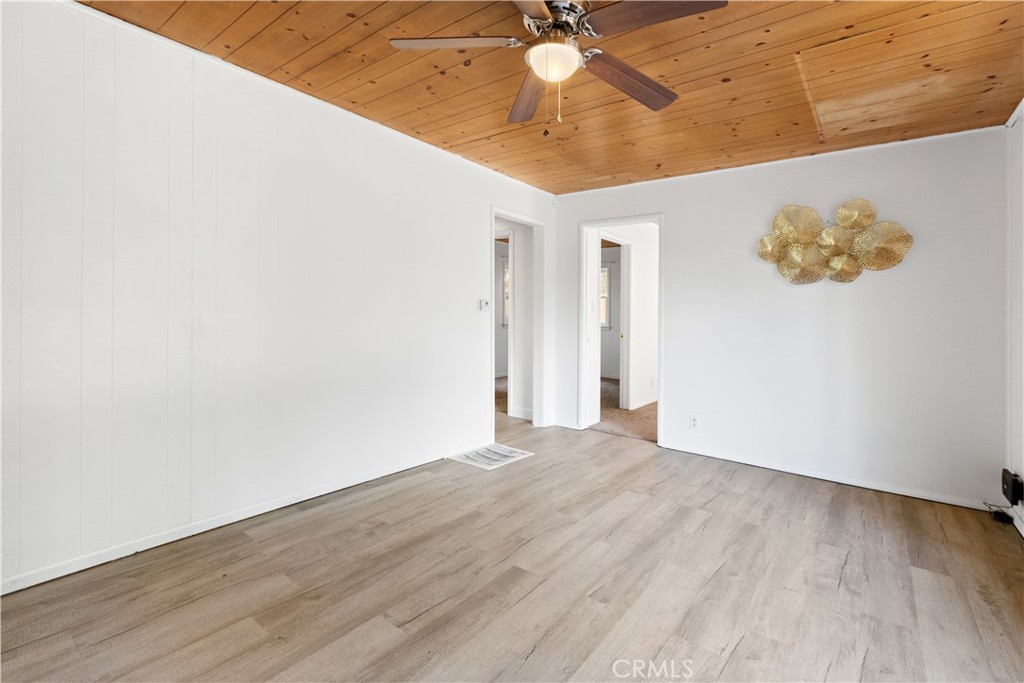 1777 Sparrow Road Wrightwood, CA 92397 - Photo 8 of 44 an empty room with wooden floor and fan