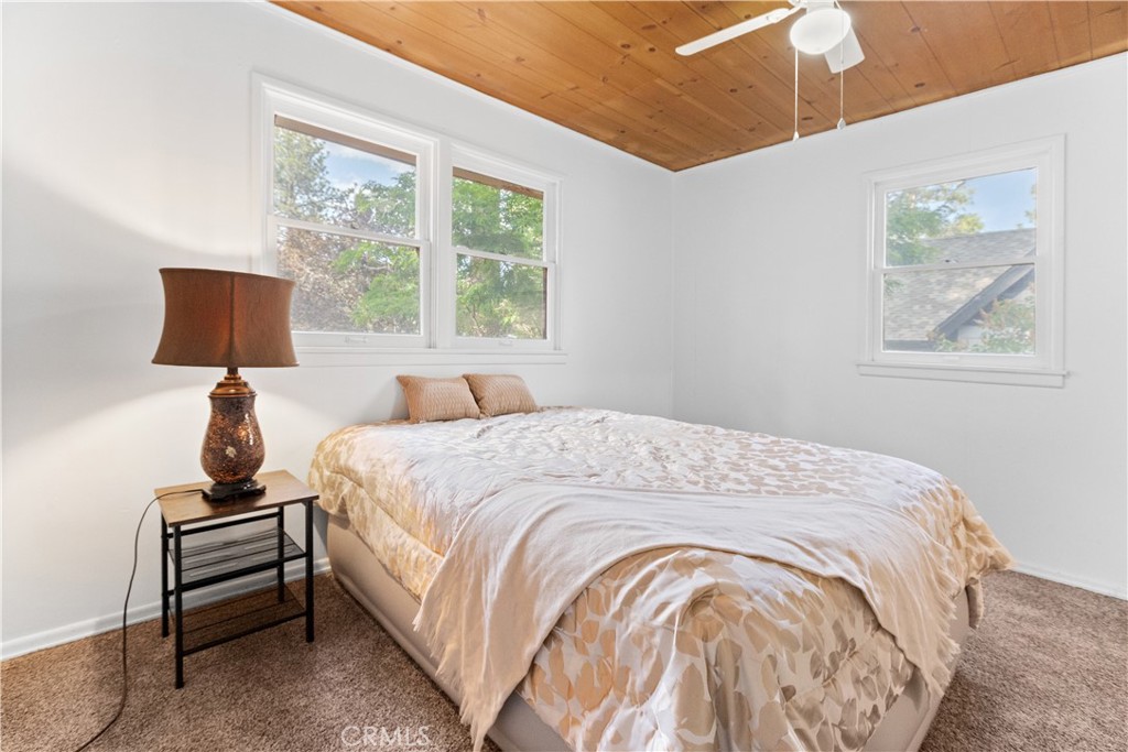 1777 Sparrow Road Wrightwood, CA 92397 - Photo 9 of 44 a large bed sitting in a bedroom next to a window