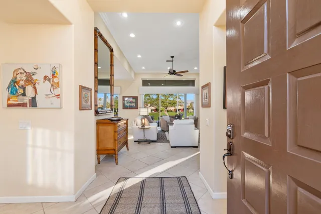a living room with furniture a flat screen tv and a table
