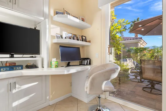 a view of a livingroom with workspace and a window