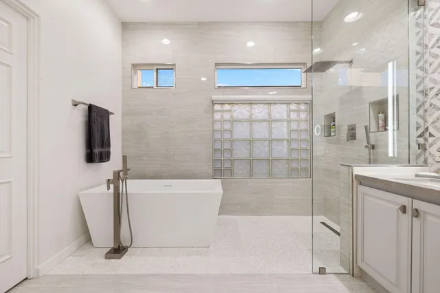 a bathroom with a shower sink and mirror