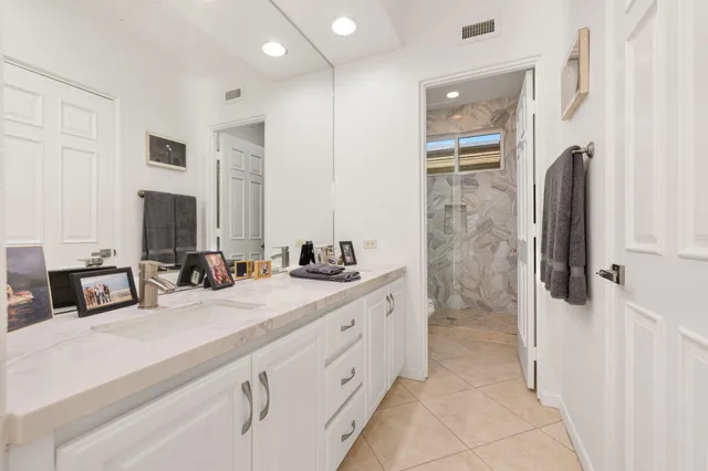 a view of a balcony with two chairs and a potted plant