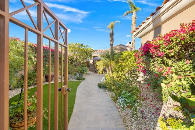 a view of a patio with a table and chairs under an umbrella