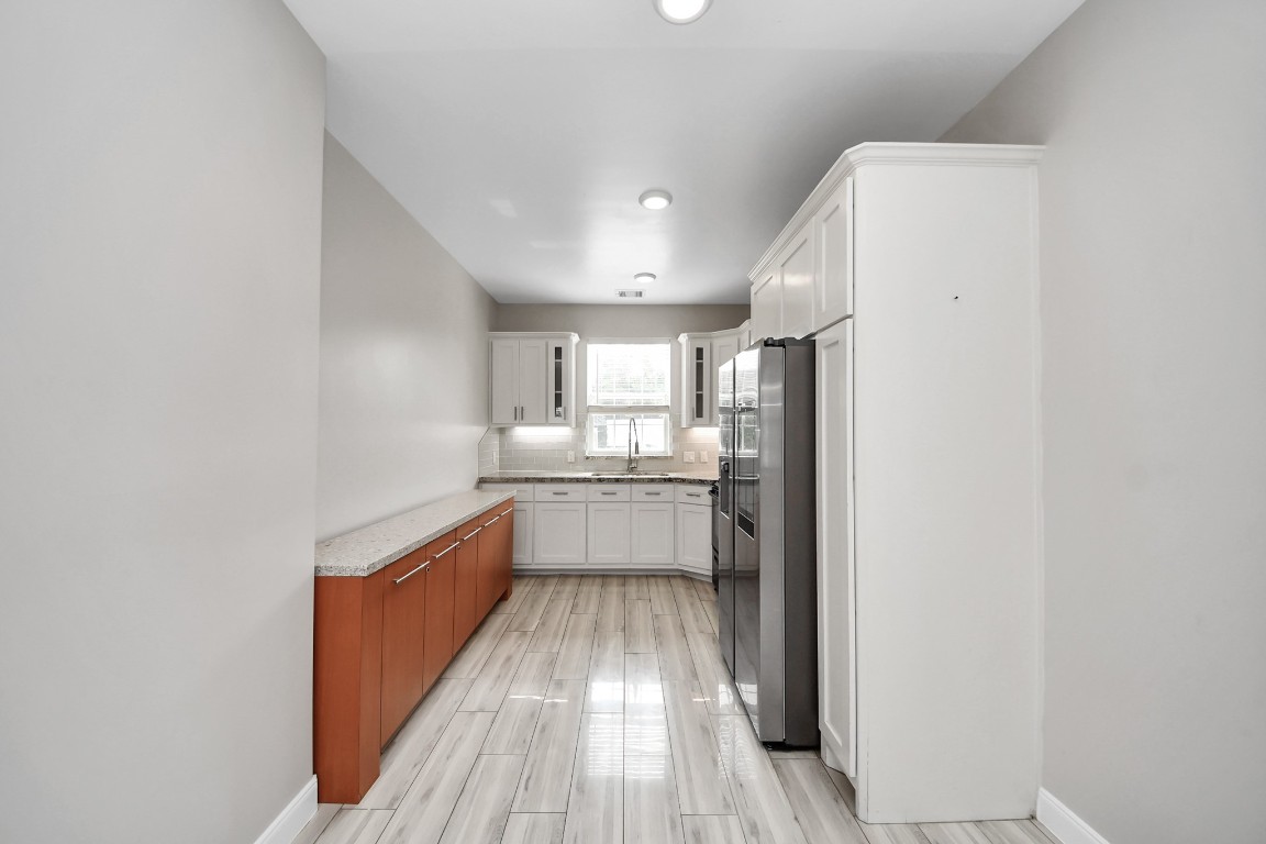 2608 Bostic Street Houston, TX 77093 - Photo 27 of 37 a large white kitchen with sink and stainless steel appliances