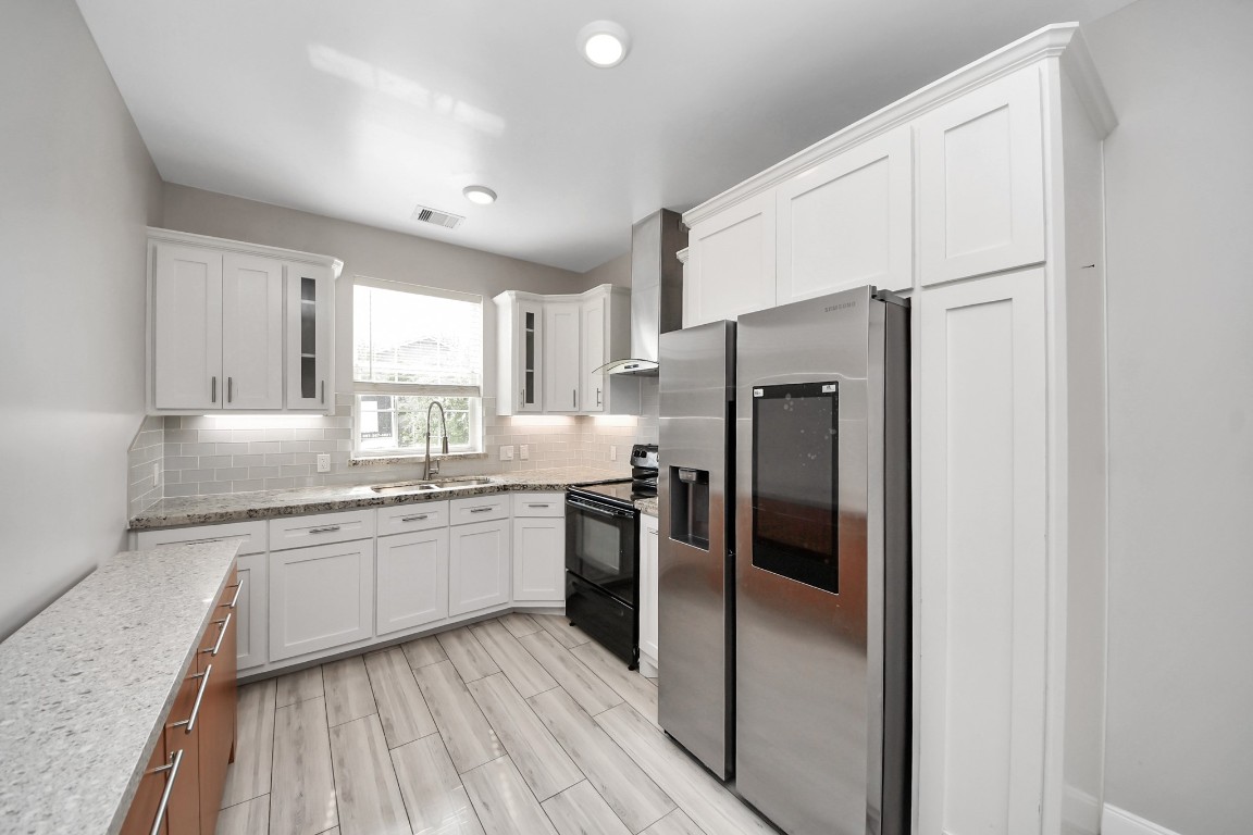 2608 Bostic Street Houston, TX 77093 - Photo 28 of 37 a kitchen with stainless steel appliances a refrigerator sink and cabinets