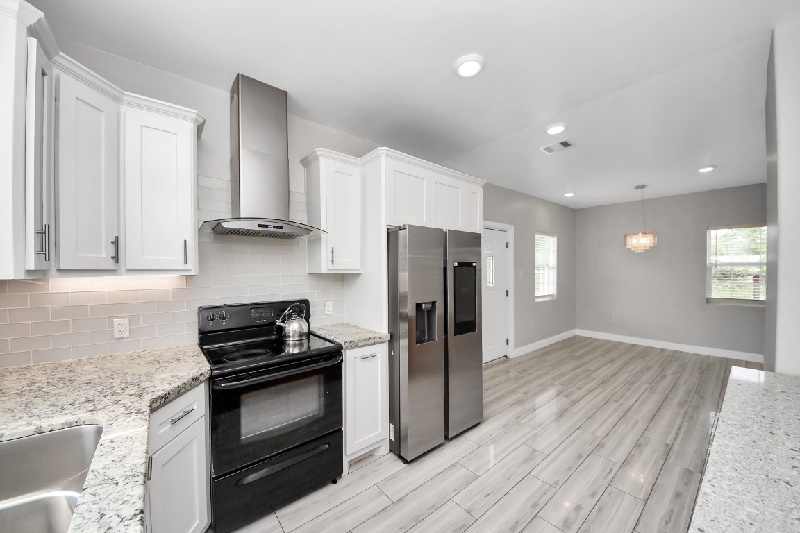 2608 Bostic Street Houston, TX 77093 - Photo 29 of 37 a kitchen with a refrigerator and a stove top oven