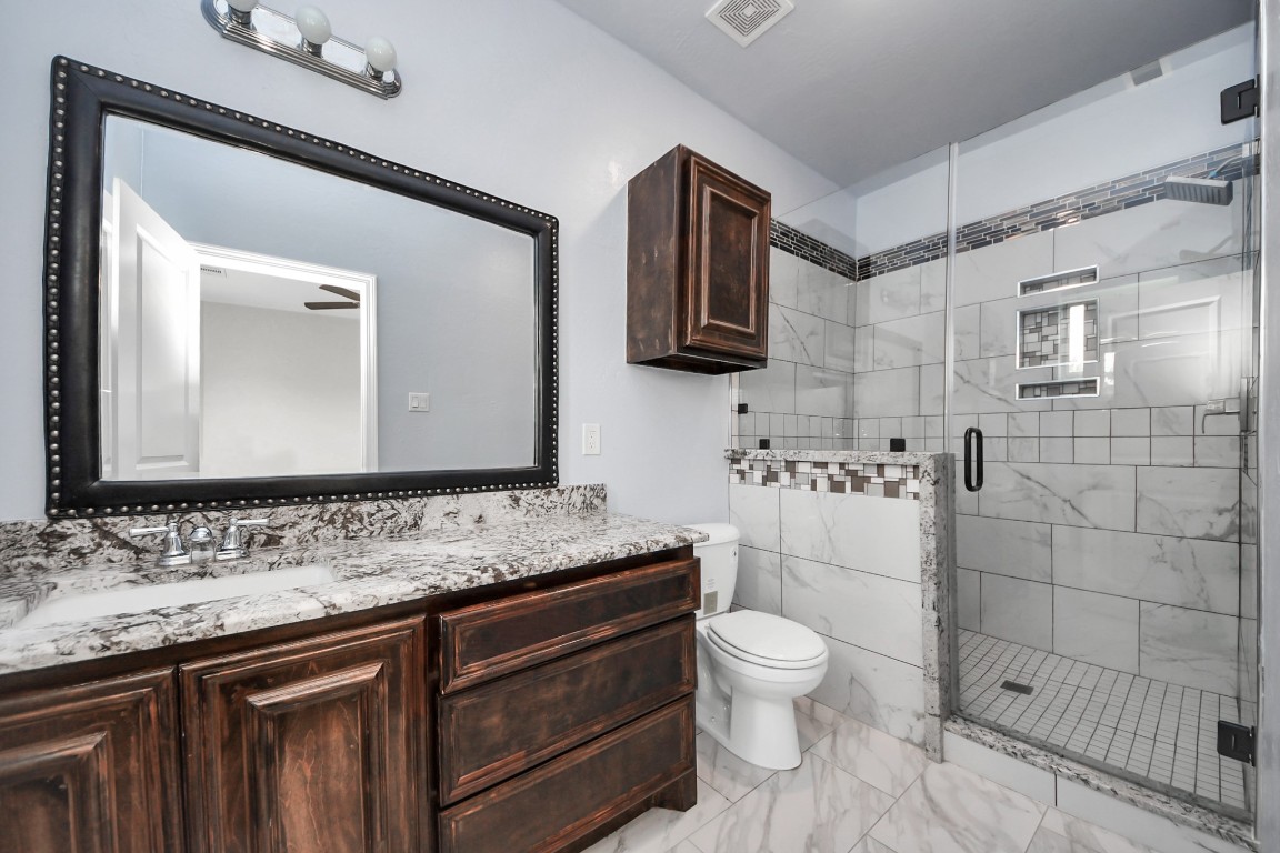 2608 Bostic Street Houston, TX 77093 - Photo 37 of 37 a bathroom with a granite countertop toilet sink and mirror