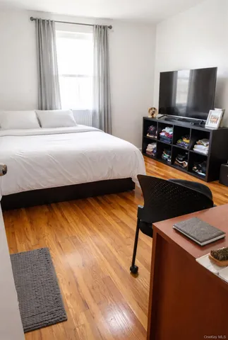 a bedroom with a bed and a television