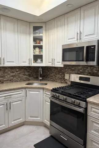 a kitchen with granite countertop cabinets and steel stainless steel appliances