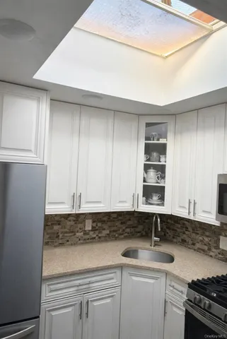 a kitchen with a sink and cabinets