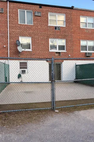 a view of a brick house with many windows