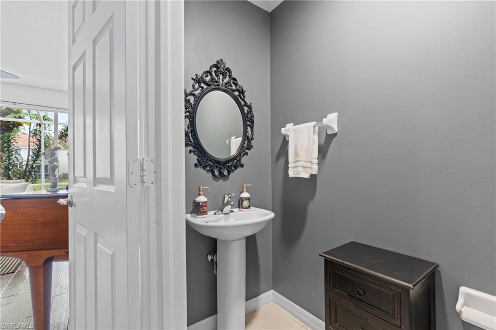 941 Hampton Circle, Unit 109 Naples, FL 34105 - Photo 17 of 27 a bathroom with a sink mirror and toilet