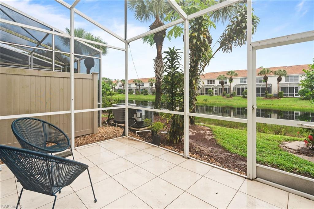 941 Hampton Circle, Unit 109 Naples, FL 34105 - Photo 19 of 27 a view of a chair and tables in the balcony