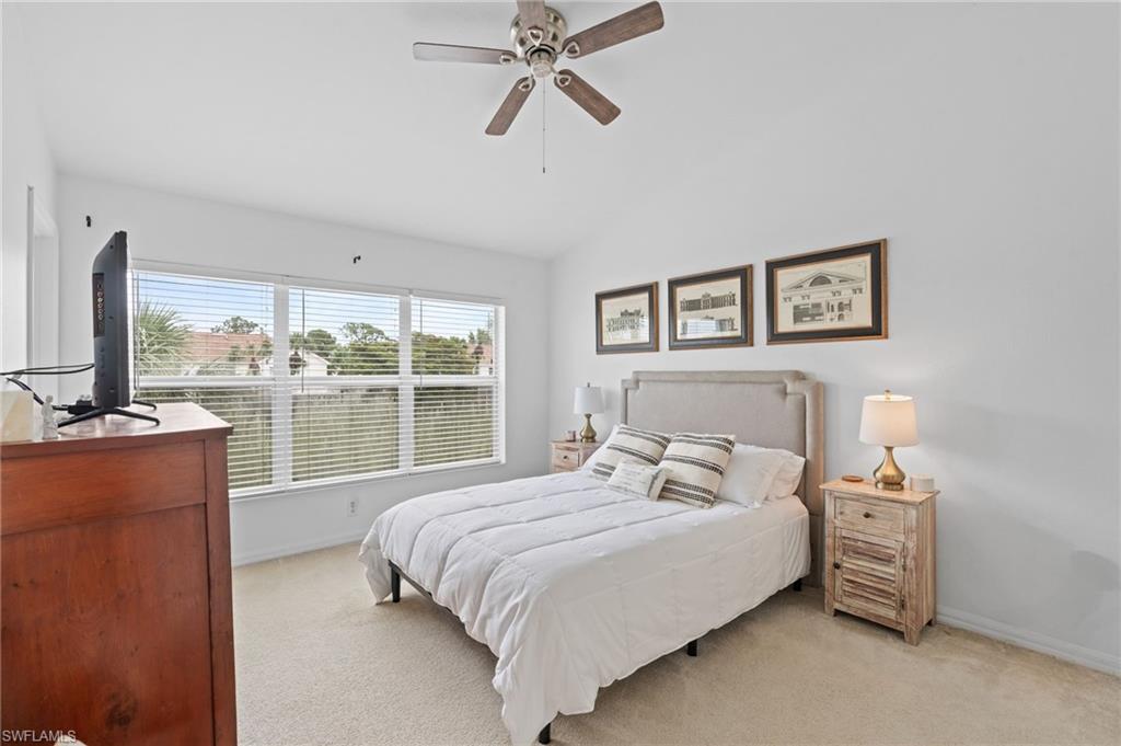 941 Hampton Circle, Unit 109 Naples, FL 34105 - Photo 20 of 27 a bedroom with a large bed and a window
