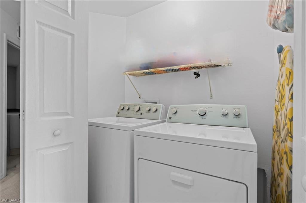 941 Hampton Circle, Unit 109 Naples, FL 34105 - Photo 26 of 27 a utility room with dryer and washer