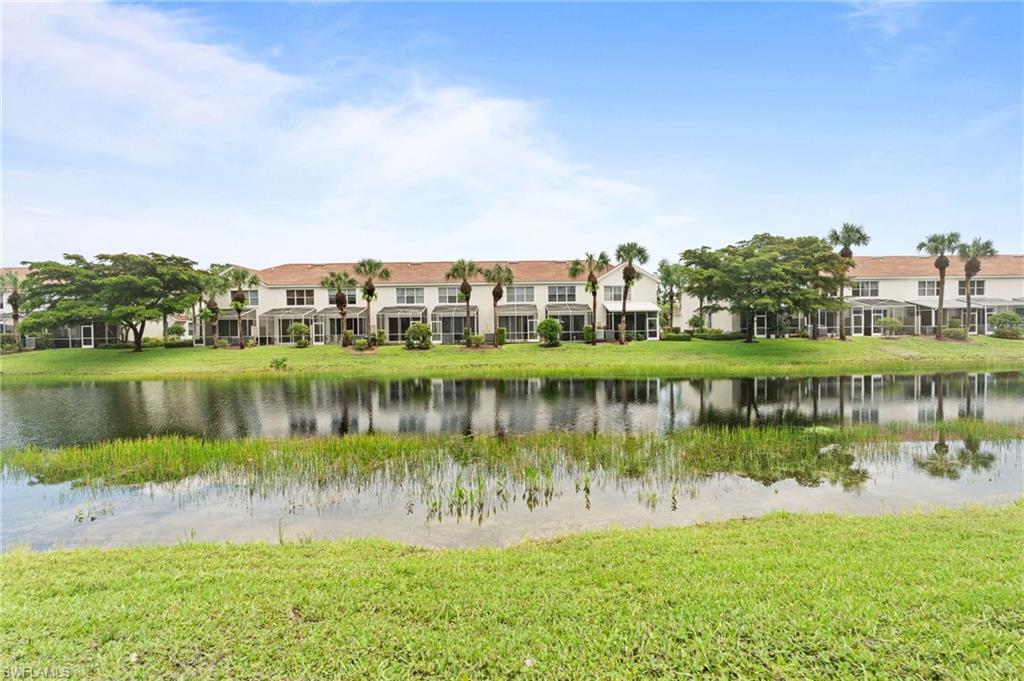 941 Hampton Circle, Unit 109 Naples, FL 34105 - Photo 5 of 27 a view of a lake with houses in the back