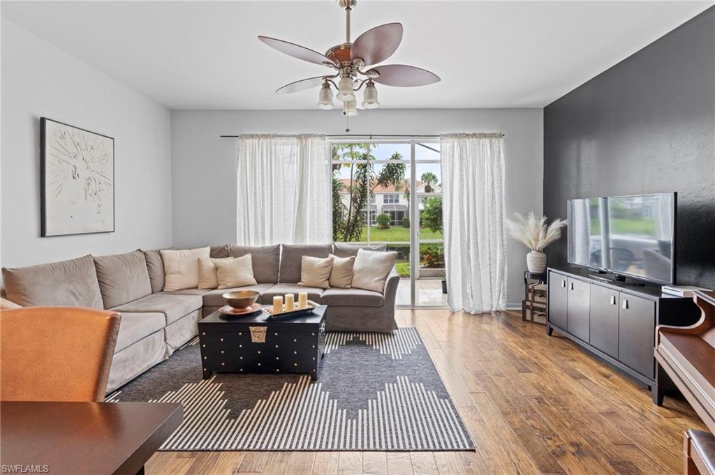 941 Hampton Circle, Unit 109 Naples, FL 34105 - Photo 8 of 27 a living room with furniture fireplace and flat screen tv