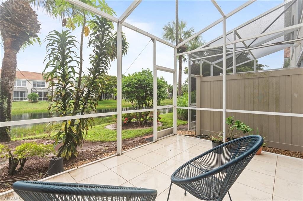 941 Hampton Circle, Unit 109 Naples, FL 34105 - Photo 9 of 27 a view of a chairs and table in the patio
