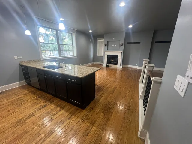a kitchen with stainless steel appliances granite countertop a sink and a stove