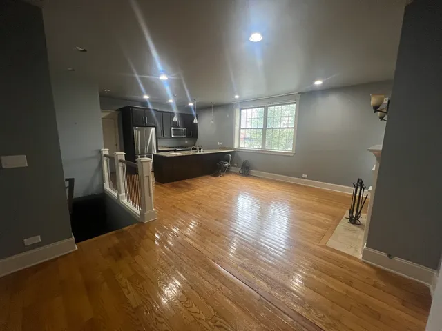 a view of a kitchen with a sink and a refrigerator