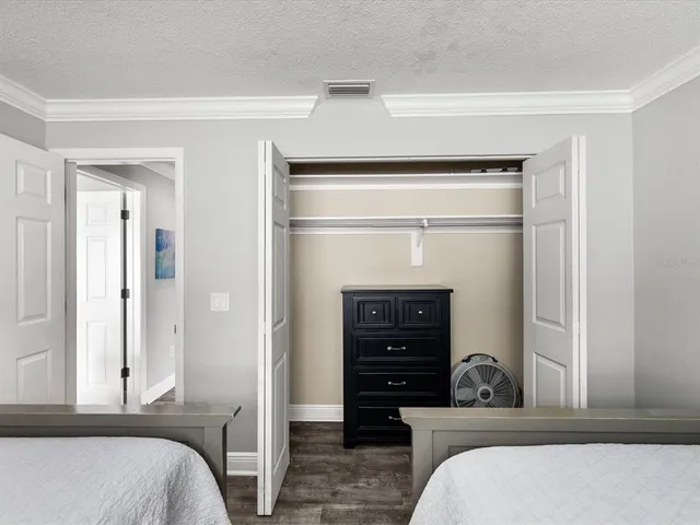 a bedroom with a bed and a dresser