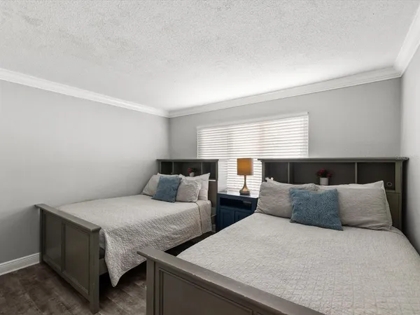 a bedroom with two beds and a night stand