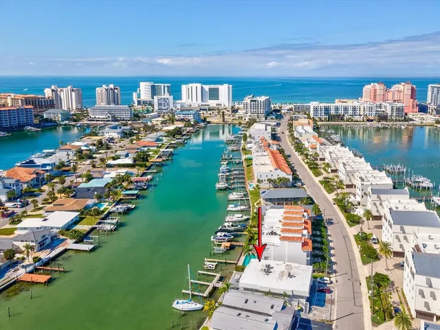 an aerial view of a house with outdoor space lake view and ocean view