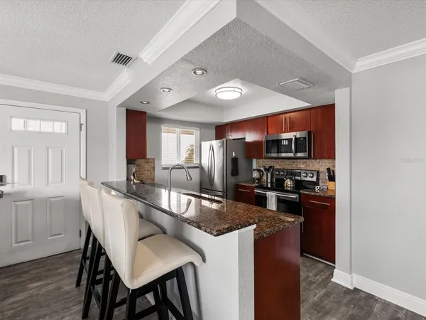 a large kitchen with a table and chairs in it