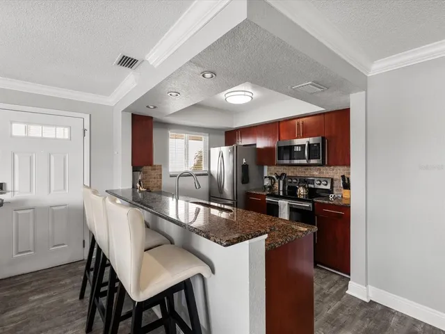 a large kitchen with a table and chairs in it