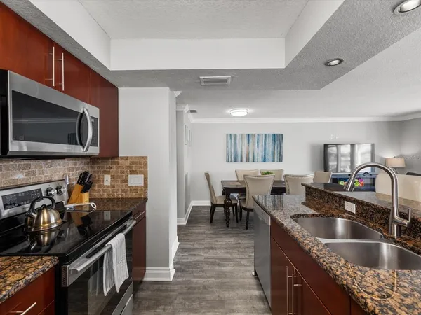 a kitchen with granite countertop a sink and appliances