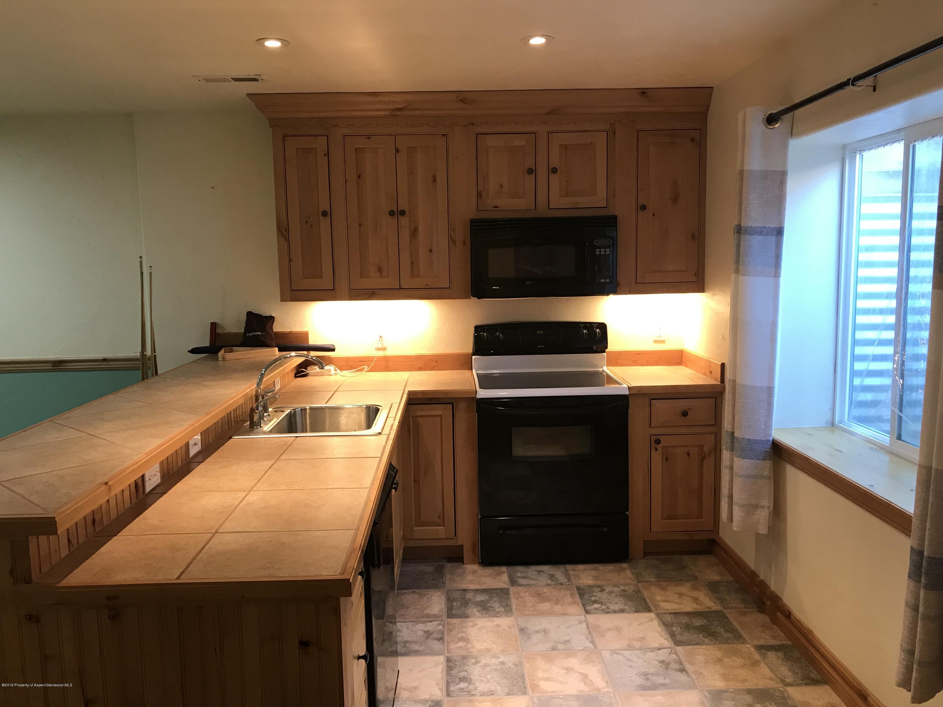 525 Birch Court Rifle, CO 81650 - Photo 12 of 17 a kitchen with a sink stove and microwave